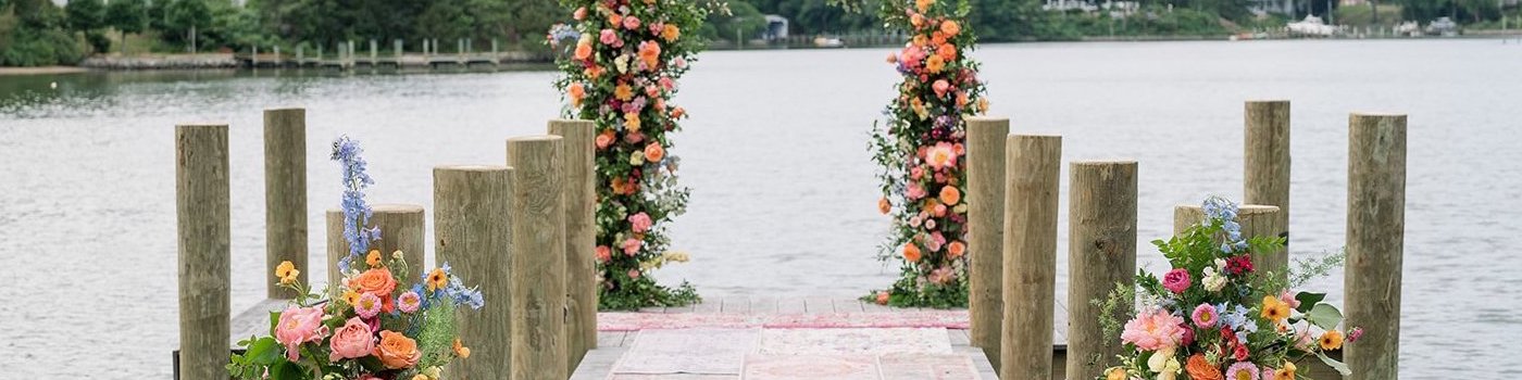 Waterfront dock decorated with flowers for a wedding. Beautiful water view