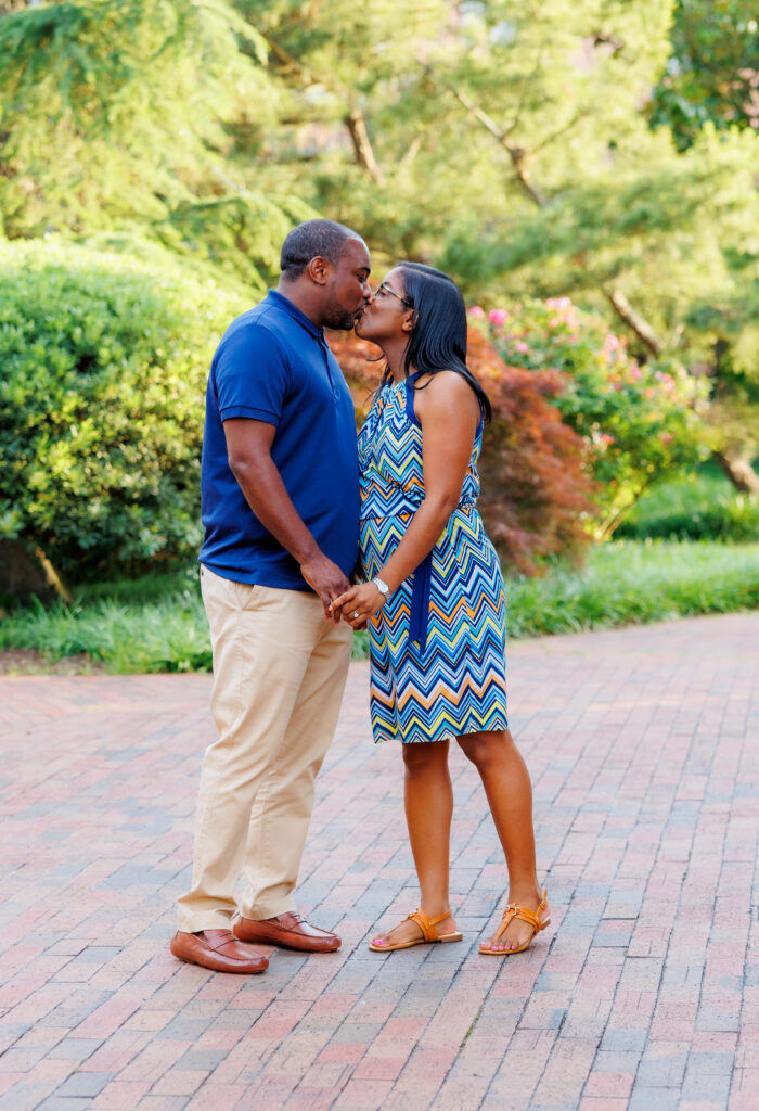 Engagement photo session with bride to be dressed in variations of blue, tan and white and groom to be dressed in royal blue shirt and tan pants.  