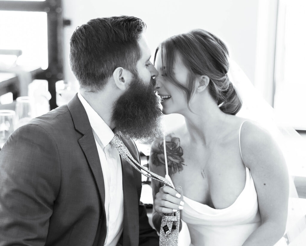 Candid moments of pure laughing and joy between a bride and groom from a Virginia Beach wedding photographer