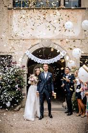 Bride and Groom exiting their  venue with gold and white paper confetti.  A Virginia Wedding Photographer loves this image.