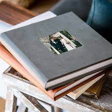 stack of different wedding albums 
